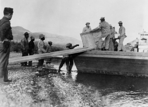 Black soldiers unloading a barge at Morley Bay, Yukon Territory 1942