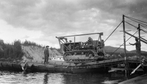 A 93rd African American D8 dozer operator loaded his machine onto a Pontoon Ferry at Johnsons Crossing. 1942