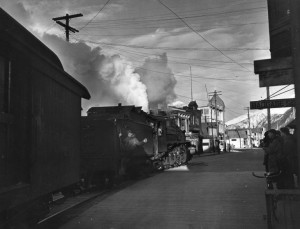 The White Pass and Yukon railroad steaming down Broadway Street in Skagway, Alaska. 1942