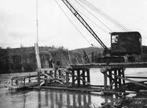 The PRA building a wooden bridge over Teslin River at Johnsons Crosssing. 1942