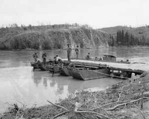 93rd Black soldiers working with the 73rd to build a pontoon ferry for the Teslin River. 1942
