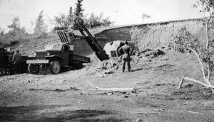 Osgood Shovel scooped more gravel and fill dirt into dump trucks for the Alaska Highway. 1942