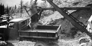 Osgood Shovel emptying a scoop of gravel and fill dirt for the Alaska Highway. 1942