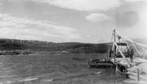 Nisutlin Bay pontoon ferry transporting equipment along the Alaska Highway. 1942