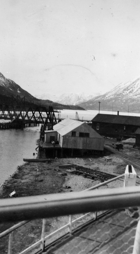 Looking from drydocked Steamboat Tutshi at railroad bridge and Lake Bennett, Carcross, YT. 1942