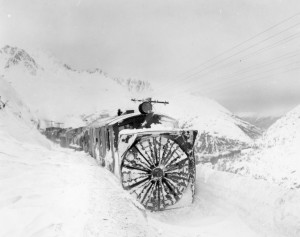 A locomotive with a rotary plow clears the tracks and continues to climb over White Pass. 1942