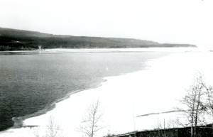 Pile driver in the background setting posts for a bridge across Nisutlin Bay. 1942