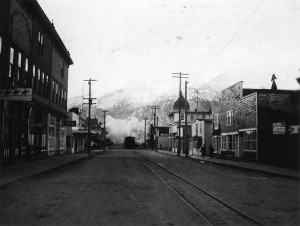 Train tracks run down Broadway Street in the city of Skagway, Alaska. 1942