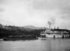 Sternwheeler from Whitehorse pushing barge loaded with equipment up Teslin Lake.1942